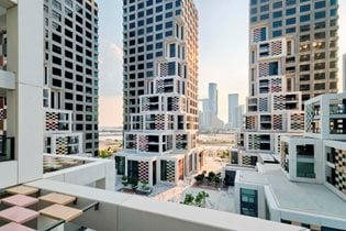 MVRDV completes Pixel, seven towers “breaking down” into formations of terraces and bay windows